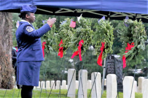 A military representative adorns the branch wreath